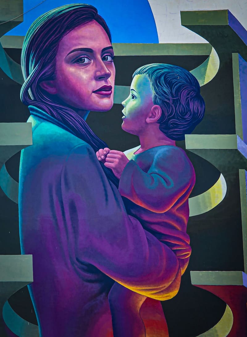 A large mural of a mother holding a child.